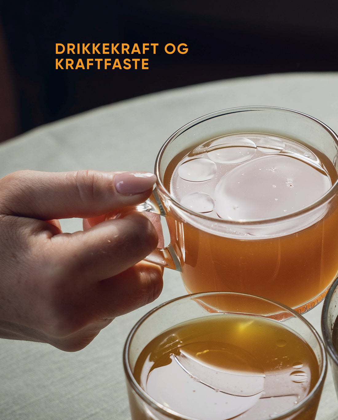 Drikkekraft og kraftfaste: hender skåler med glass kraft